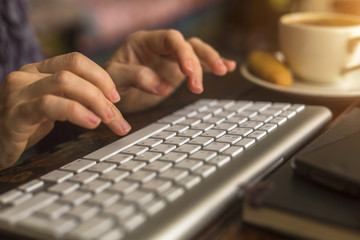 Female typing on the computer keyboard.