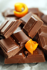 Chocolate with orange peels on parchment, closeup