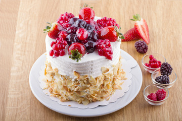 Whole White Berry Fruit Cake on Wooden Table