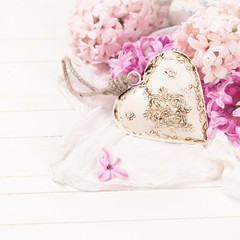 Background with fresh pink  hyacinths and decorative heart