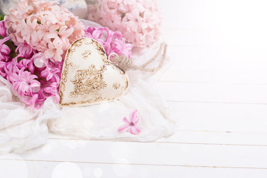 Background with fresh pink  hyacinths and decorative heart