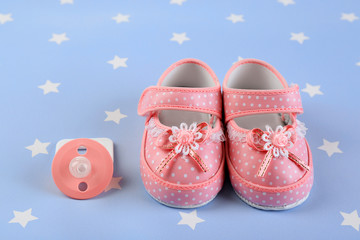 Baby shoes on blue background
