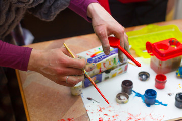 Naklejka premium Hands stained with clay and paint. Hands painter and sculptor. C