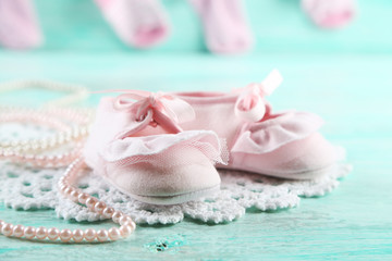Cute toddler shoes on wooden background