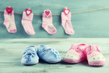 Cute toddler shoes and socks on wooden background