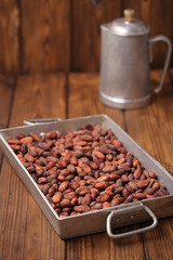 roasted cocoa chocolate beans in Vintage heavy cast aluminum roa