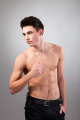 Fototapeta premium Muscular built man with a dog tags.