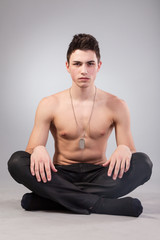 Fototapeta premium Healthy muscular young man on grey background