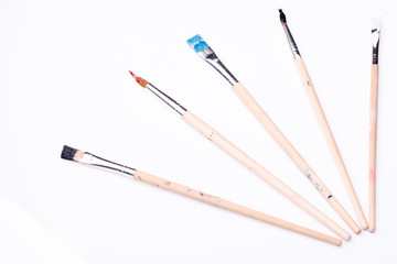 Five paintbrushes on a white background