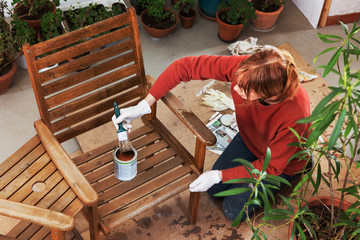 Sanding and painting an outdoor bench