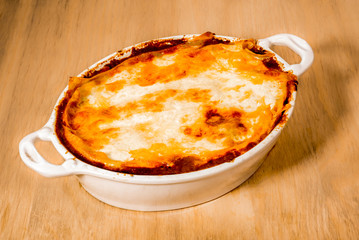 White ceramic dish of lasagna straight from the oven