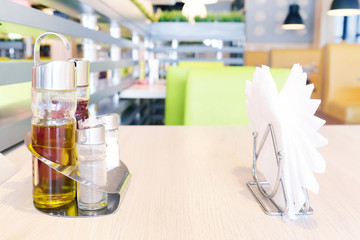 Bottles with olive oil, vinegar, salt and pepper, napkin