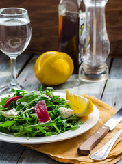 Fresh green salad with beets, goat cheese and olive oil