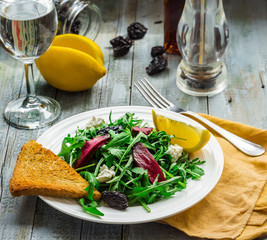 green salad with arugula, beets, goat cheese and prunes, ruddy t