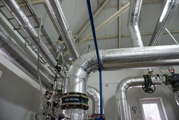 Place in a large industrial boiler room.