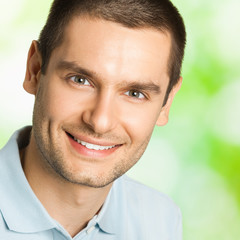 Portrait of young happy smiling man, outdoors