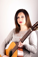 Fototapeta premium Studio shot of a woman holding guitar