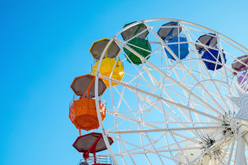 Detail of a colorful ferris wheel seen at a fair