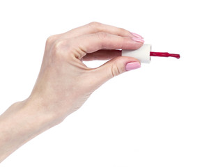 female hands with red manicure and nail polish bottle with brush