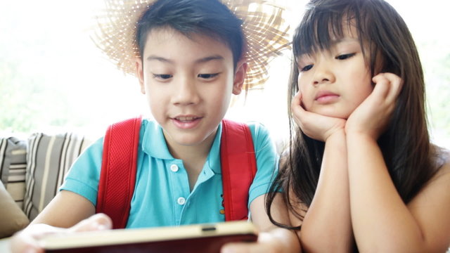 Asian child playing smart phone together