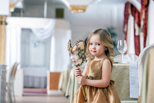 Image of adorable little girl posing with mask