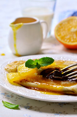 Crepes with chocolate filling and orange syrup.