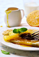 Crepes with chocolate filling and orange syrup.