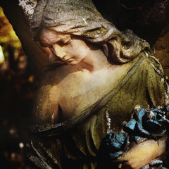 sculpture of an angel with dark background