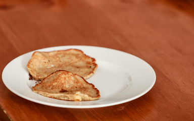 Fried apple in pancake dough or apple fritters with icing sugar