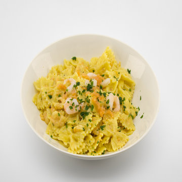 italian pasta called butterflies with shrimp salmon and basil
