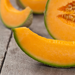 Fresh melons on old wooden background. Selective focus.