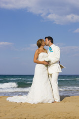 Fototapeta na wymiar Bride and groom at the beach