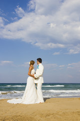 Fototapeta na wymiar Bride and groom at the beach
