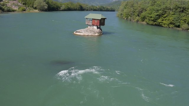 small house built on the rock in the river Drina
