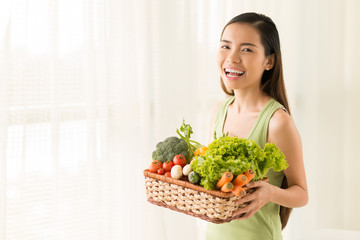 Woman with basket of vegetables