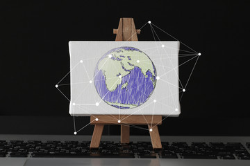 hand drawn globe with social network diagram on canvas and woode