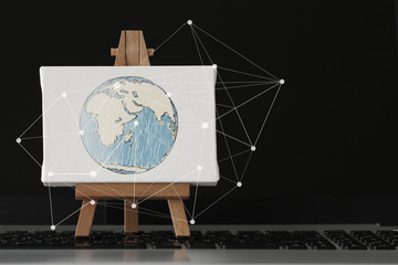 hand drawn globe with social network diagram on canvas and woode