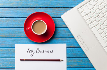 coffee and paper with My Business words near notebook