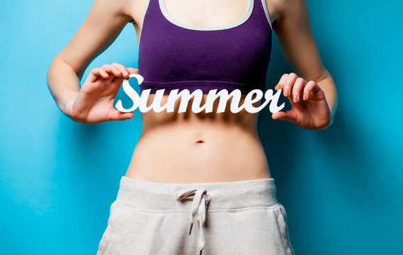 Woman showing her abs with Summer word inscription