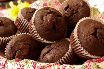 A napkin lined basket filled with chocolate muffins