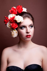 Girl with flowers in her head on brown background