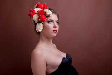 Girl with flowers in her head on brown background