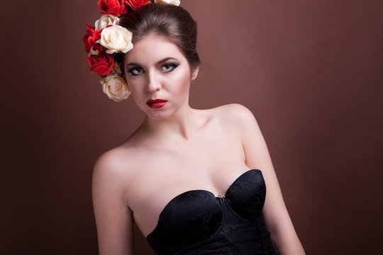 Girl with flowers in her head on brown background