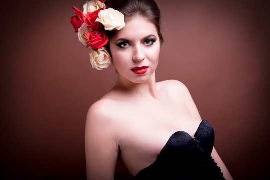 Girl with flowers in her head on brown background