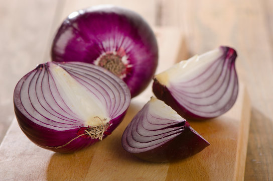 Fresh red onions on   wooden board