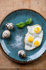 Breakfast with fried quail eggs, view from above, close-up