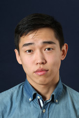 Romantic young Asian man looking at camera