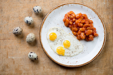 Breakfast with fried eggs and beans, studio shot, above view