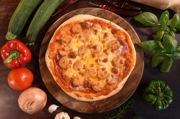 pizza and fresh vegetables for pizza on the wooden background