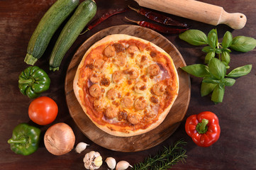 pizza and fresh vegetables for pizza on the wooden background